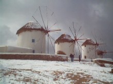 MYKONOS WINDMILLS WITH SNOW AT WINTER